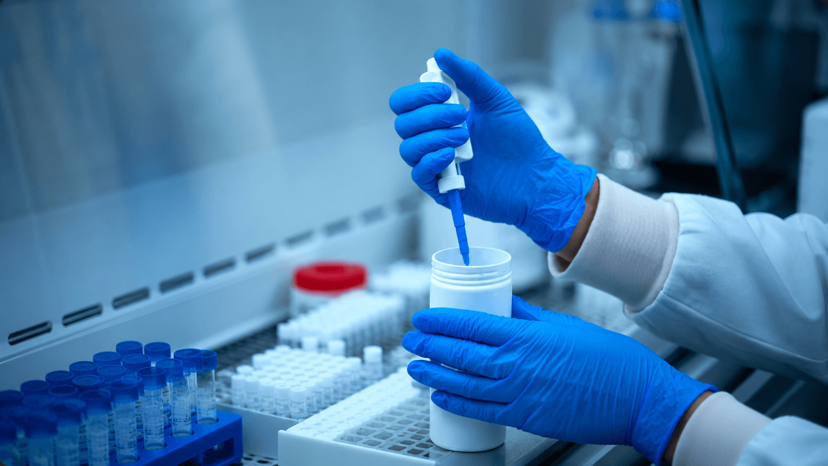 Scientist pipetting a genomic sample in the laboratory